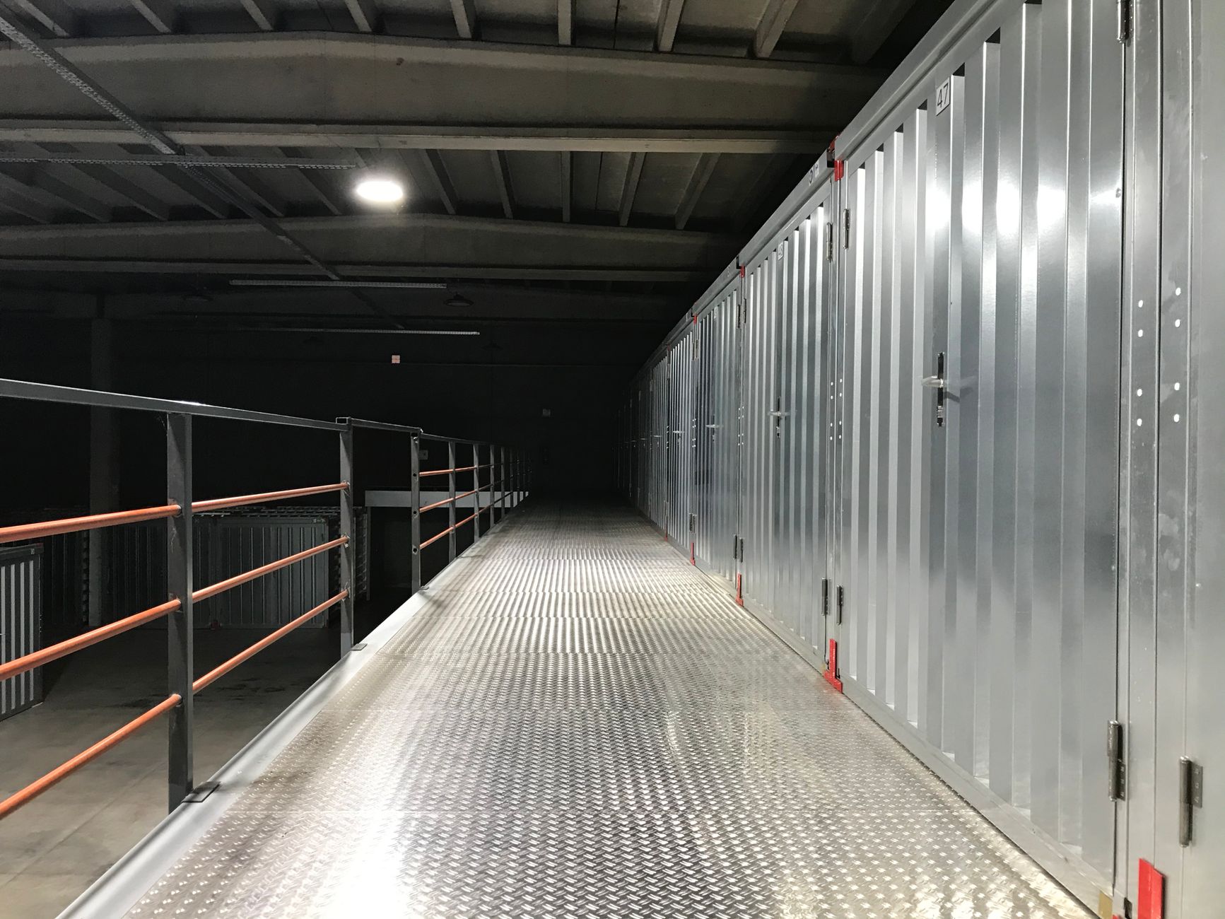 A long data center corridor lined with server racks and blue ceiling lights