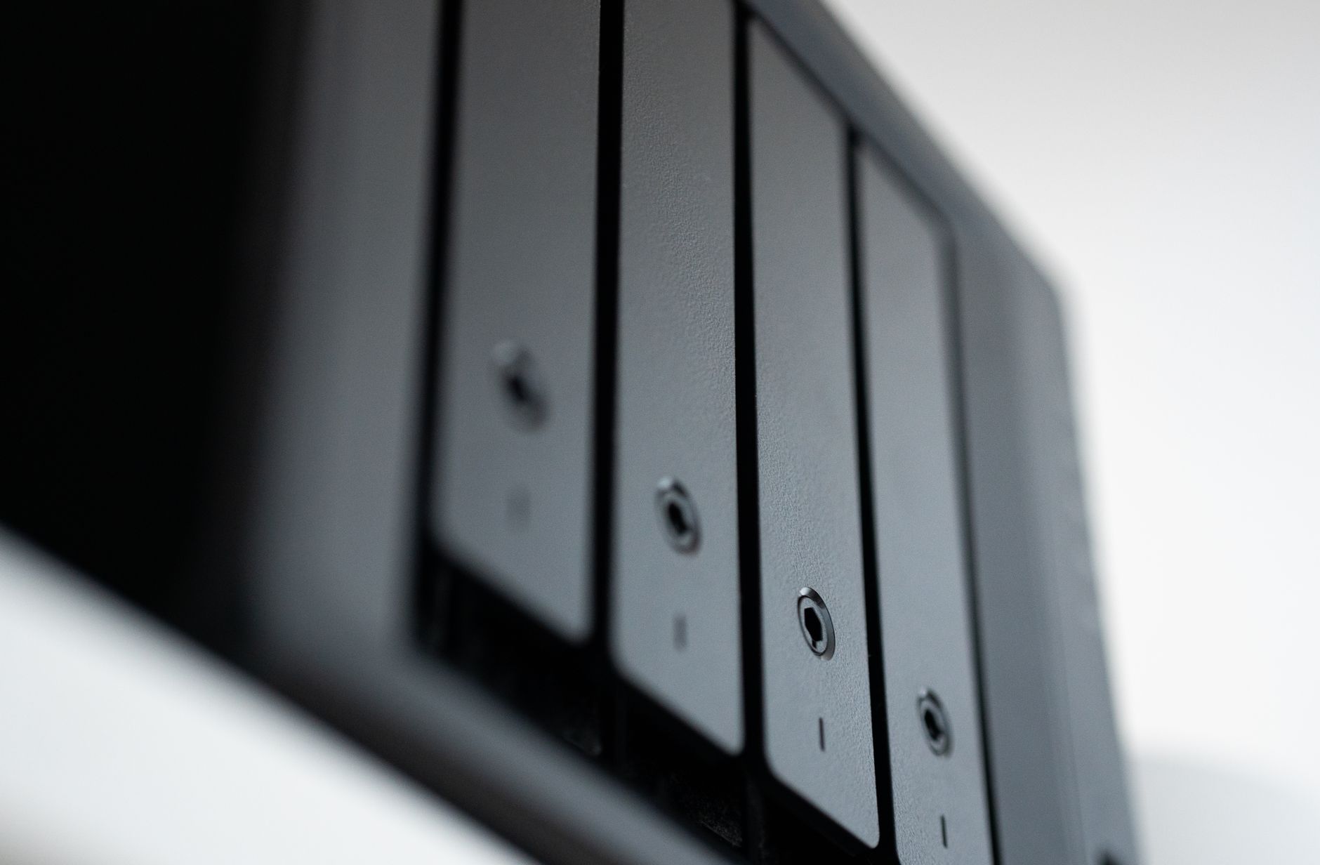 Rows of storage drives with green status lights in a data center storage array