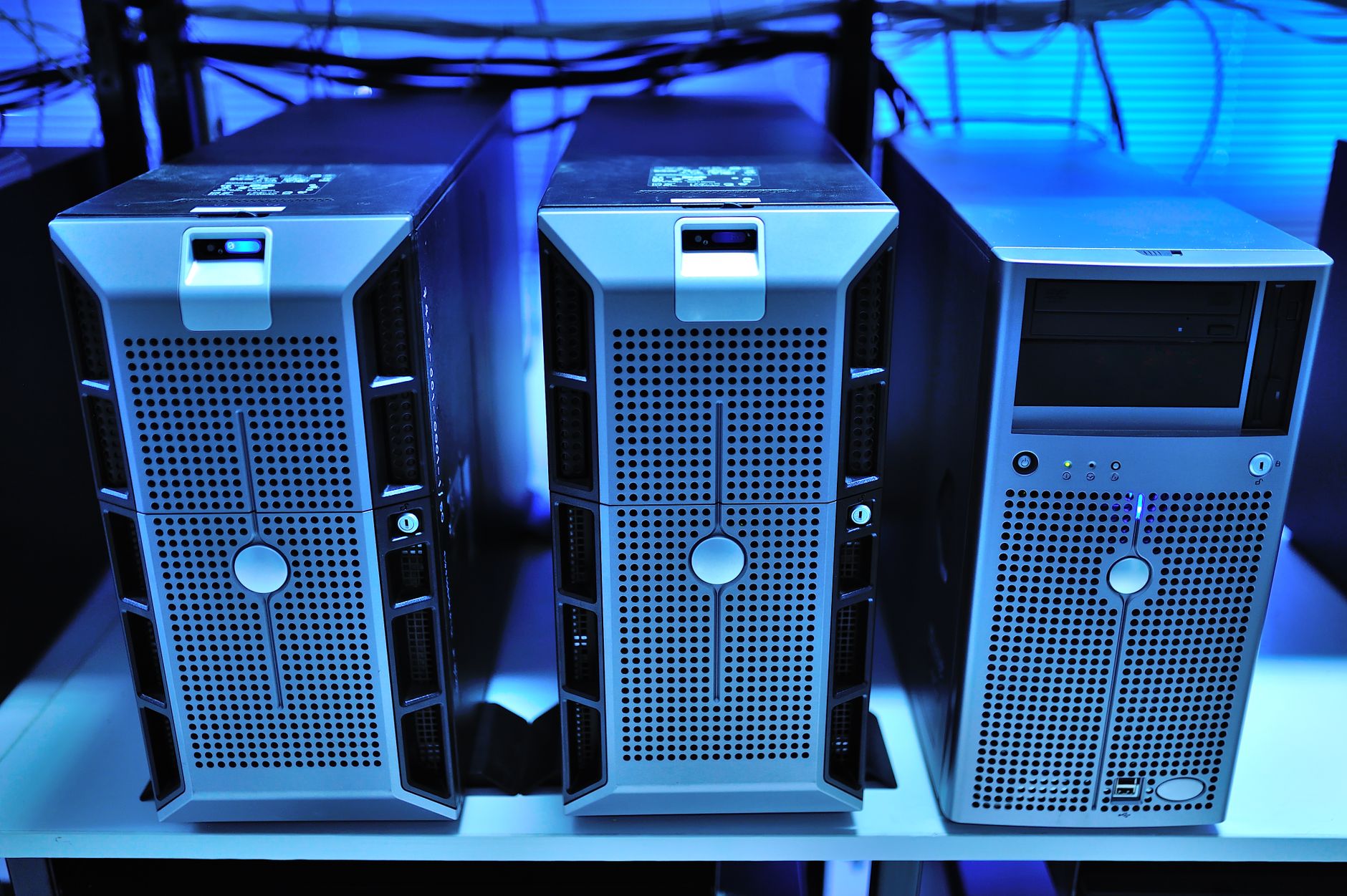 A mostly empty server rack with a few blinking units in a dim data center aisle